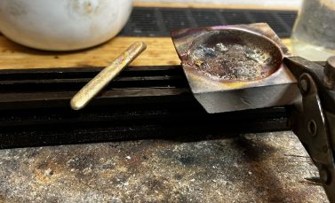 Oud goud wordt omgesmolten in het atelier van een goudsmid voor een maatwerk hanger